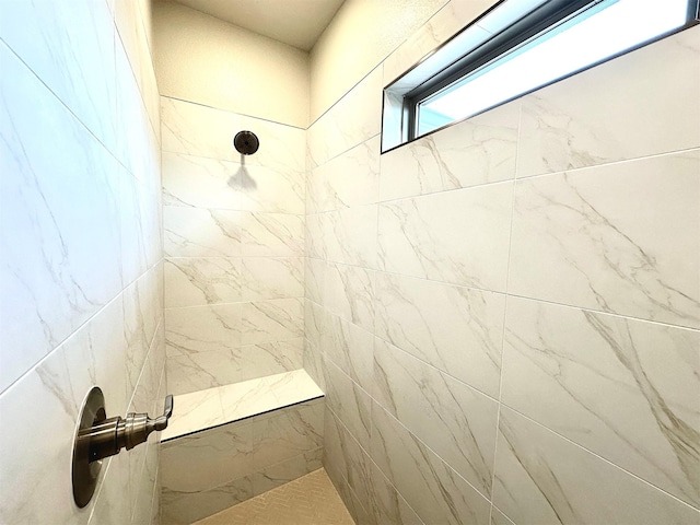 bathroom with a tile shower