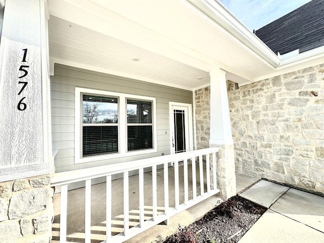 view of exterior entry with a porch