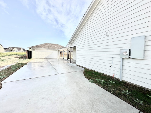 view of property exterior featuring a garage and an outbuilding