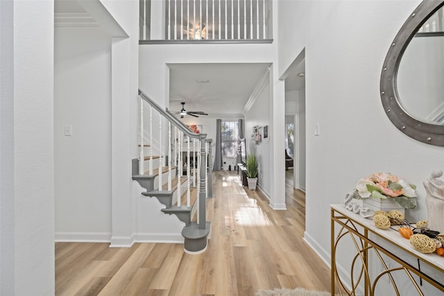 entrance foyer featuring ceiling fan, light hardwood / wood-style flooring, and ornamental molding