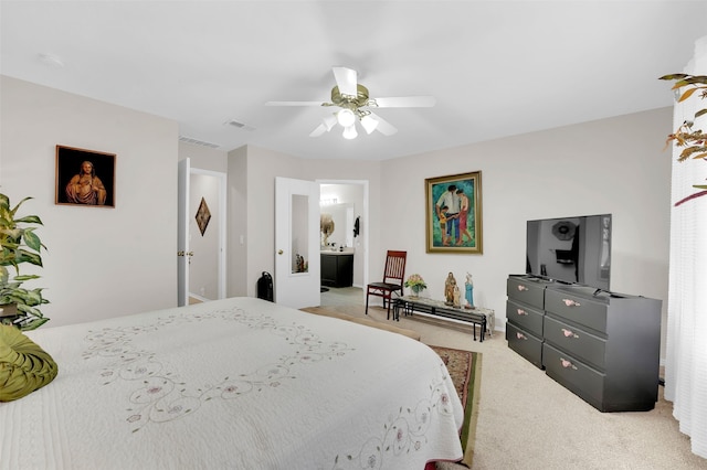 carpeted bedroom featuring ceiling fan and ensuite bathroom