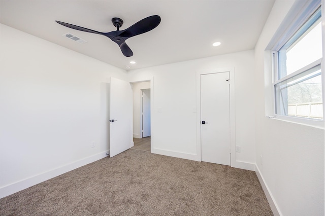 unfurnished bedroom with ceiling fan, light colored carpet, and a closet