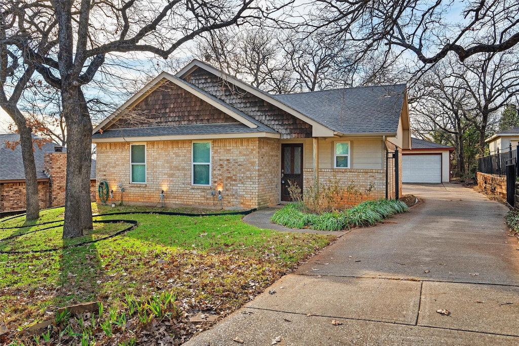 view of front of house featuring a garage and a front lawn