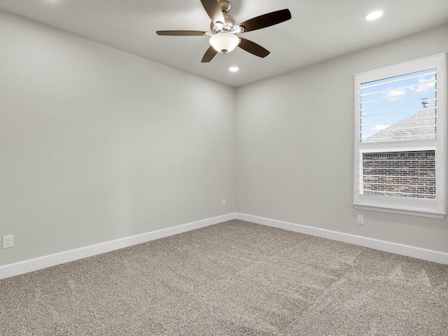 spare room featuring ceiling fan and carpet