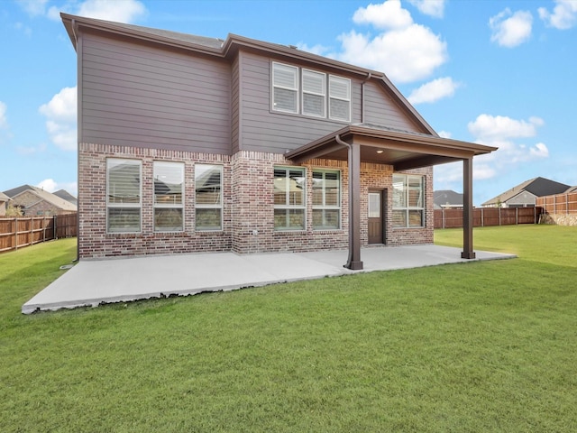 rear view of property featuring a patio area and a yard