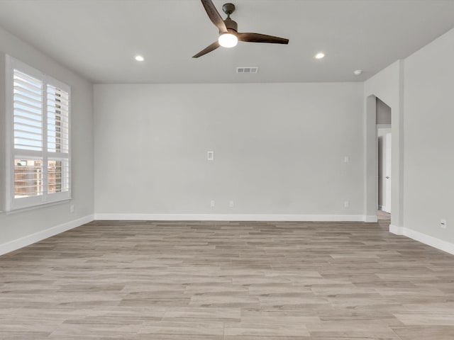 spare room with ceiling fan and light hardwood / wood-style flooring