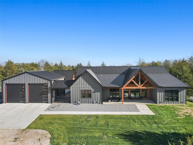 view of front of home with a front yard and a garage