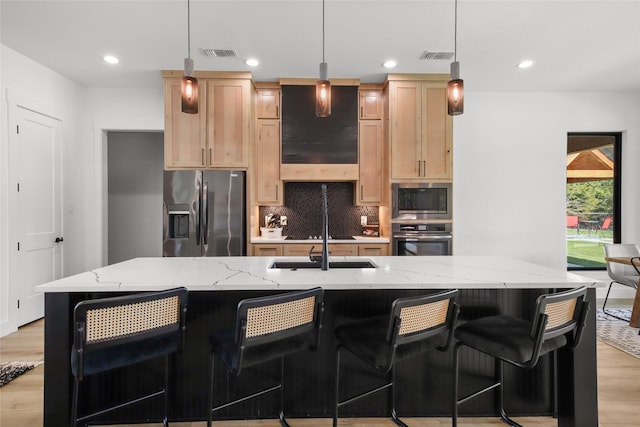 kitchen with stainless steel refrigerator with ice dispenser, decorative light fixtures, built in microwave, light brown cabinetry, and wall oven