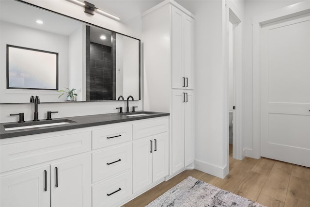 bathroom featuring vanity, wood-type flooring, and toilet