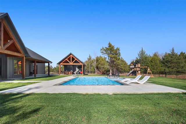 view of swimming pool with a playground, a patio area, and a lawn