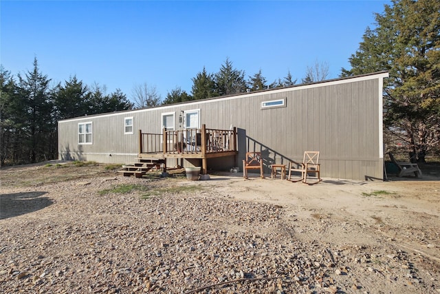 back of property with a wooden deck