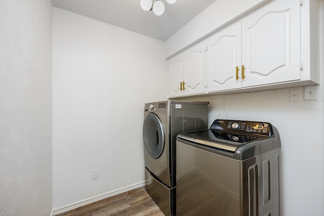 laundry room with cabinets, independent washer and dryer, and dark hardwood / wood-style flooring