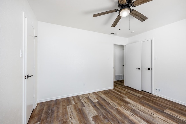 unfurnished bedroom with ceiling fan and dark hardwood / wood-style flooring