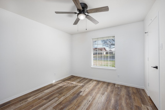 empty room featuring dark hardwood / wood-style floors and ceiling fan