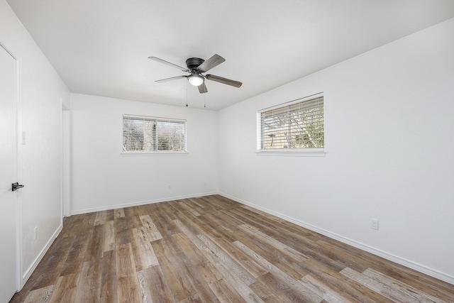 unfurnished room with ceiling fan and hardwood / wood-style flooring