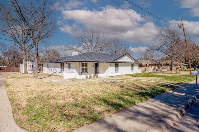 view of front of house with a shed, a front lawn, and a porch