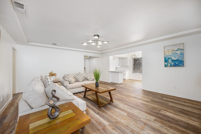 living room featuring hardwood / wood-style flooring and a chandelier