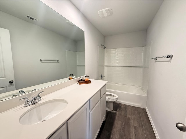 full bathroom with hardwood / wood-style flooring, vanity, toilet, and shower / washtub combination