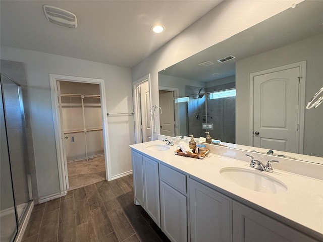 bathroom featuring vanity and a shower with shower door