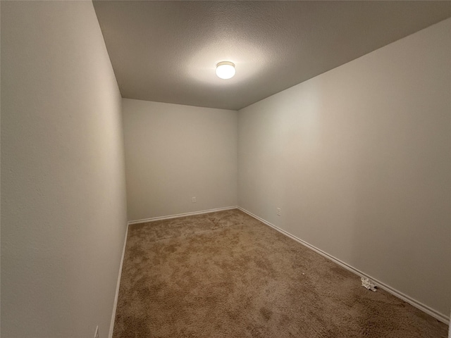 empty room featuring light carpet and a textured ceiling