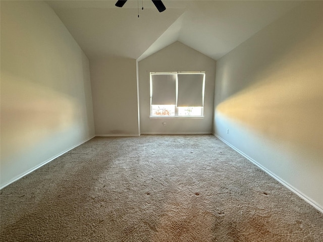 carpeted empty room with ceiling fan and lofted ceiling