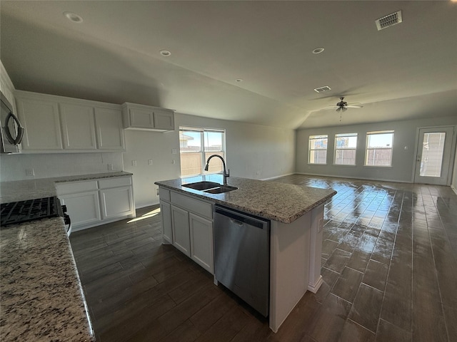 kitchen featuring stainless steel dishwasher, white cabinetry, and sink