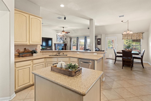 kitchen featuring sink, stainless steel dishwasher, kitchen peninsula, decorative backsplash, and ceiling fan with notable chandelier