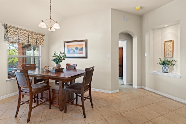 tiled dining room featuring a notable chandelier