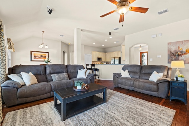 living room with ceiling fan, dark wood-type flooring, and vaulted ceiling