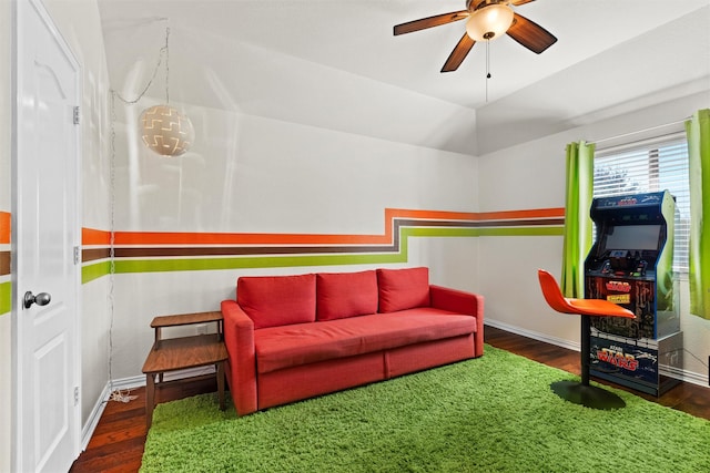 interior space featuring dark hardwood / wood-style floors, ceiling fan, and vaulted ceiling