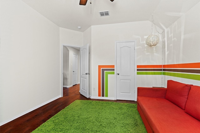 interior space with ceiling fan and dark hardwood / wood-style flooring