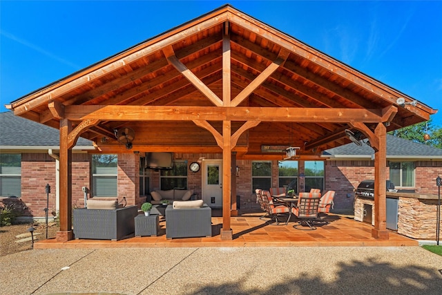 view of patio / terrace with an outdoor living space, an outdoor kitchen, and grilling area