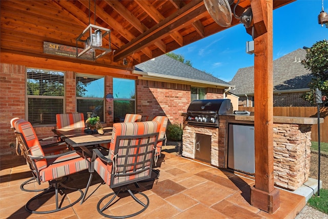 view of patio with grilling area and an outdoor kitchen