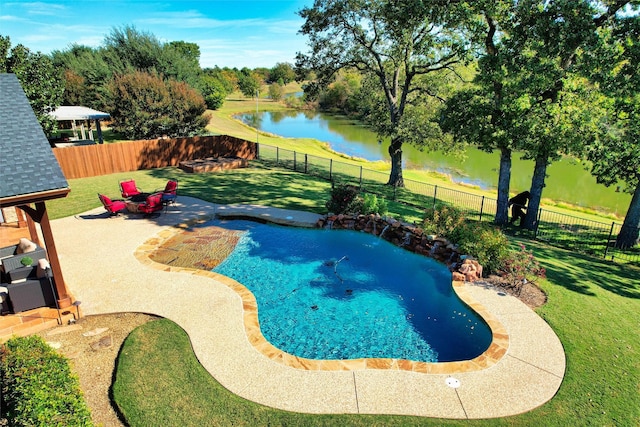 view of pool with a yard, a water view, and a patio area