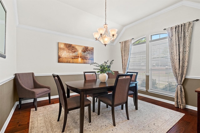 dining space featuring dark hardwood / wood-style flooring, vaulted ceiling, and crown molding