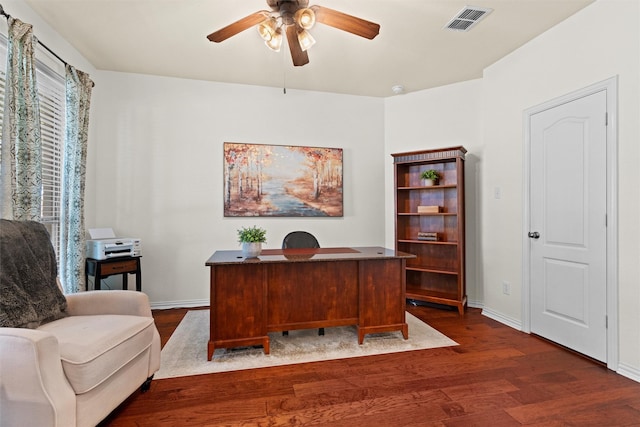 home office with dark hardwood / wood-style floors and ceiling fan