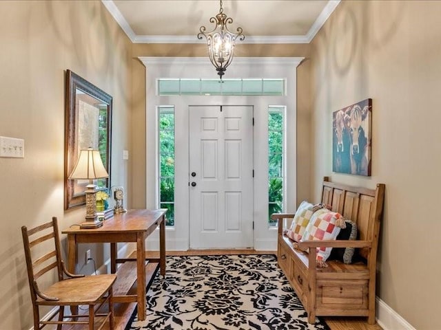 entrance foyer with a notable chandelier and crown molding