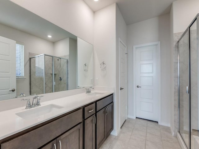 bathroom featuring tile patterned floors, vanity, and an enclosed shower