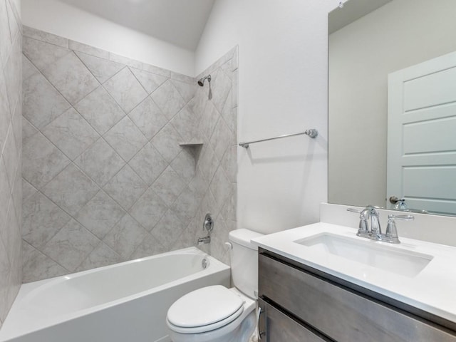 full bathroom featuring tiled shower / bath combo, toilet, and vanity