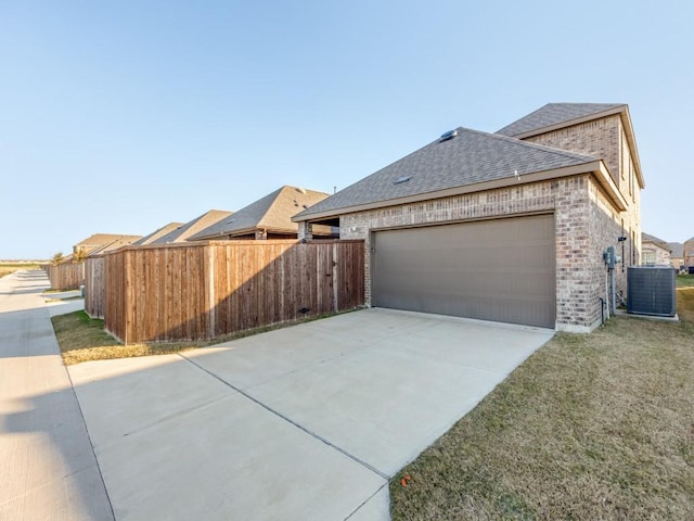 view of home's exterior with a garage and central AC