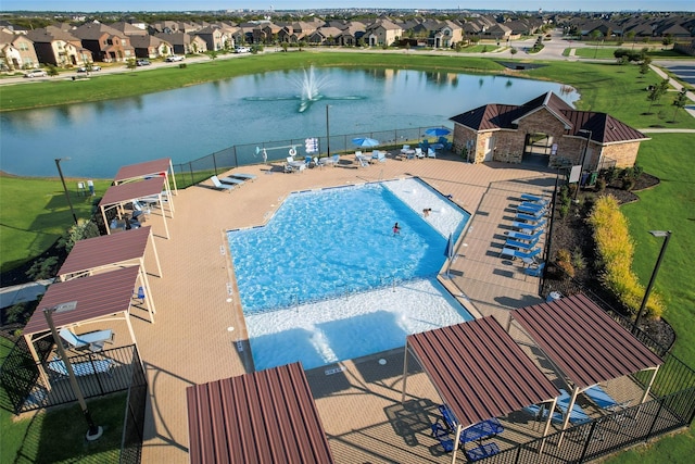 view of pool featuring a water view and a patio area