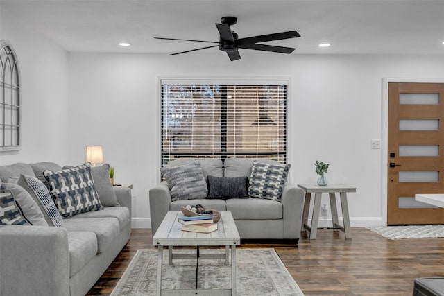 living area featuring baseboards, wood finished floors, a ceiling fan, and recessed lighting