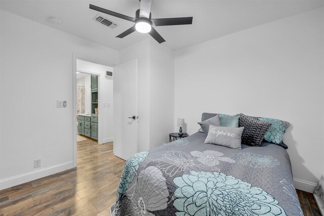 bedroom with visible vents, ceiling fan, baseboards, and wood finished floors