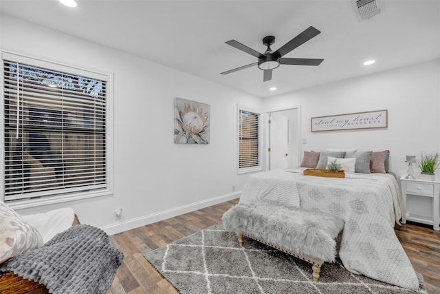 bedroom featuring baseboards, visible vents, wood finished floors, and recessed lighting