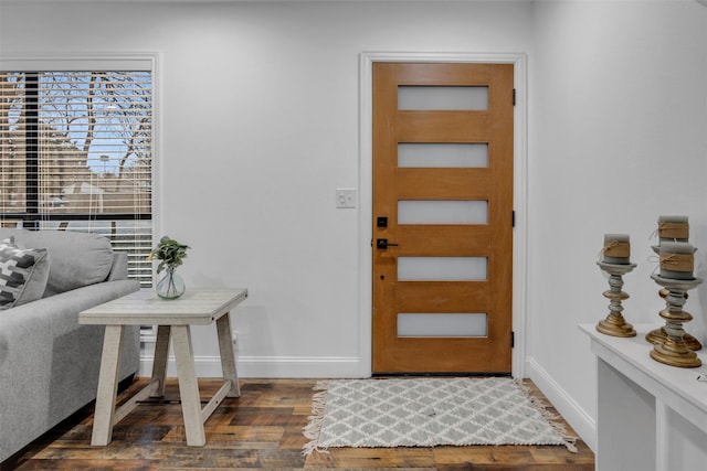 entrance foyer with baseboards and wood finished floors