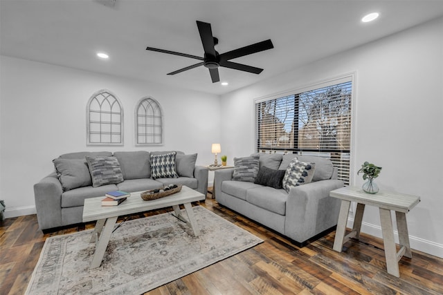 living area featuring a ceiling fan, baseboards, dark wood-style flooring, and recessed lighting