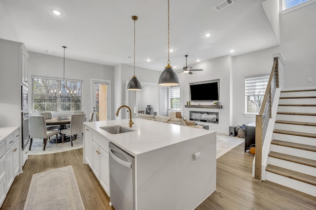 kitchen with white cabinets, a kitchen island with sink, and appliances with stainless steel finishes