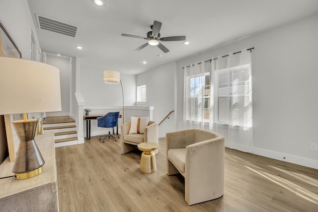 living area featuring ceiling fan and light hardwood / wood-style floors