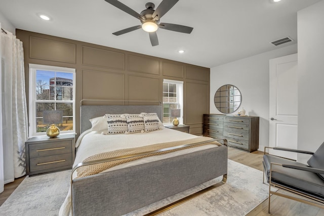 bedroom with ceiling fan and light hardwood / wood-style floors