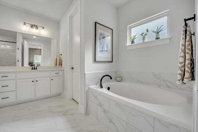 bathroom with vanity and tiled bath